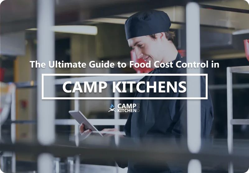 A camp kitchen manager reviewing food cost figures on a tablet beside a stainless steel prep counter.